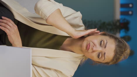 Vertical-video-of-Home-office-worker-woman-scratches-her-ears-looking-at-camera.